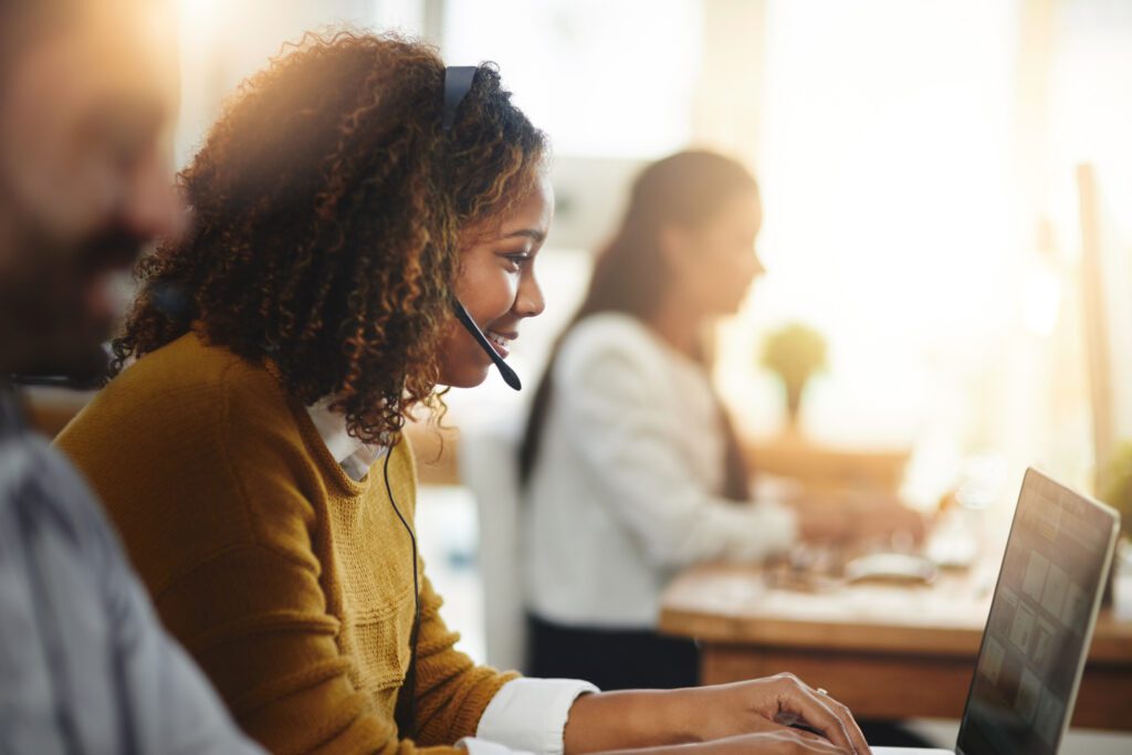 woman at computer with VoIP headset on