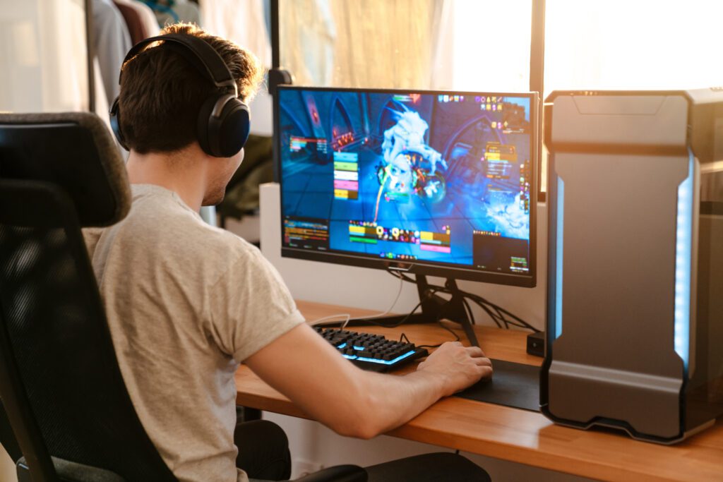 A man sits at his computer playing an online game.