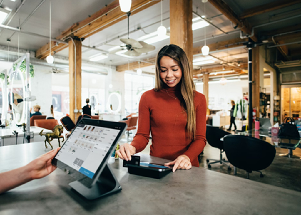 customer and worker using kiosk to take order