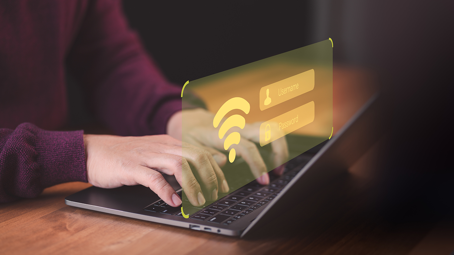 A woman using a laptop with a representation of a wifi screen digitally added above her hands.